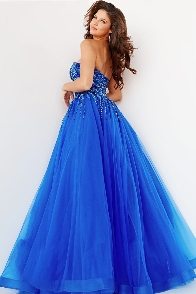 A woman wears the Jovani Strapless Sweetheart Long Prom Gown 07946, featuring a beaded bodice, as she stands against a plain white background.